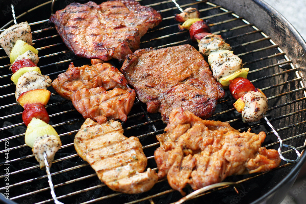 Meat and skewers on the grill