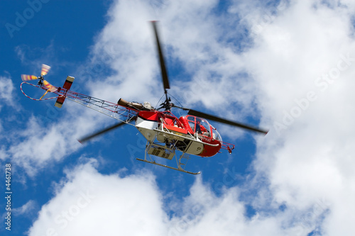 Red helicopter on the blue sky