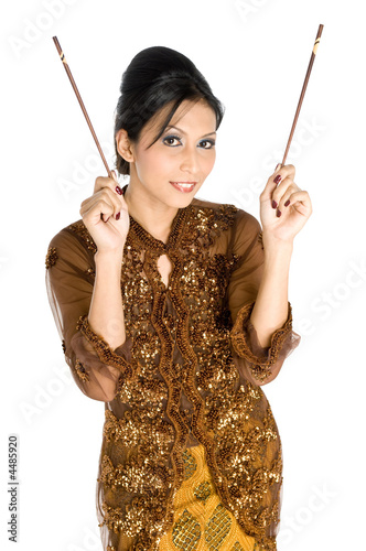 Beautiful asian girl playing with chopsticks