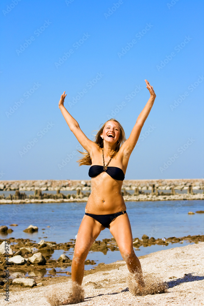 Jump of the young girl on a beach Jump of the young girl on a beach