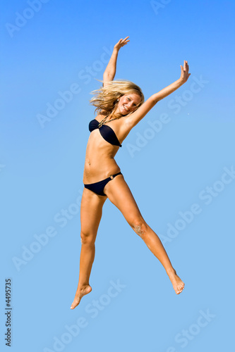 Jump of the young girl on a beach