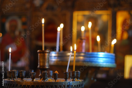 burning candles in an empty church photo