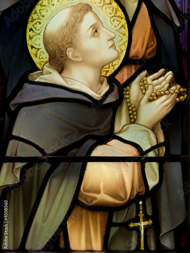Saint with a rosary deep in prayer