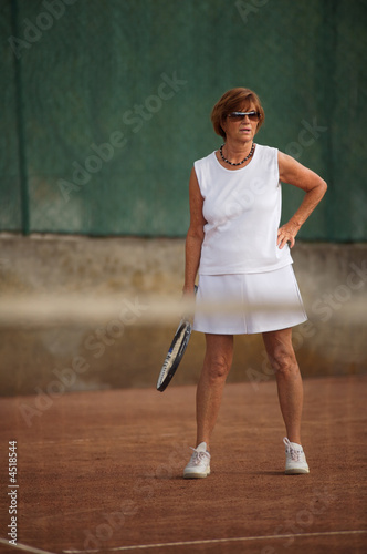 Senior woman plays tennis