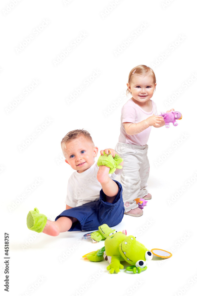 Fototapeta premium Babies play with toys