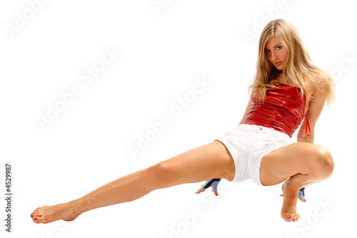 Beautiful blond girl in tension in gymnastic pose