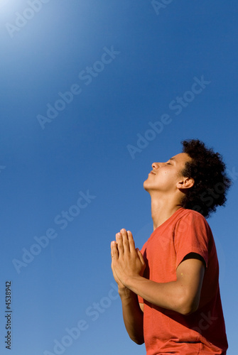 happy christian boy praying with joy