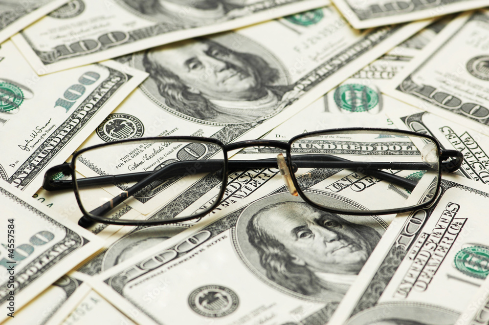Reading glasses over the dollar bank notes Reading glasses over the dollar bank notes