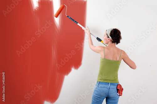 Woman painting on wall