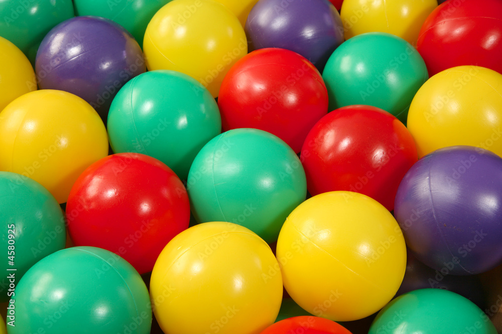 Lots of colorful plastic play balls. Lots of colorful plastic play balls.