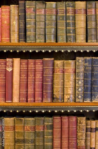 Lots of old books on a bookshelf in library.