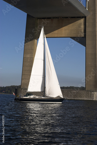 Sailboat on Little Belt sailing under suspension bridge © mema