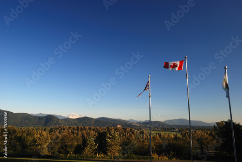 canada and bc flags with mountain background