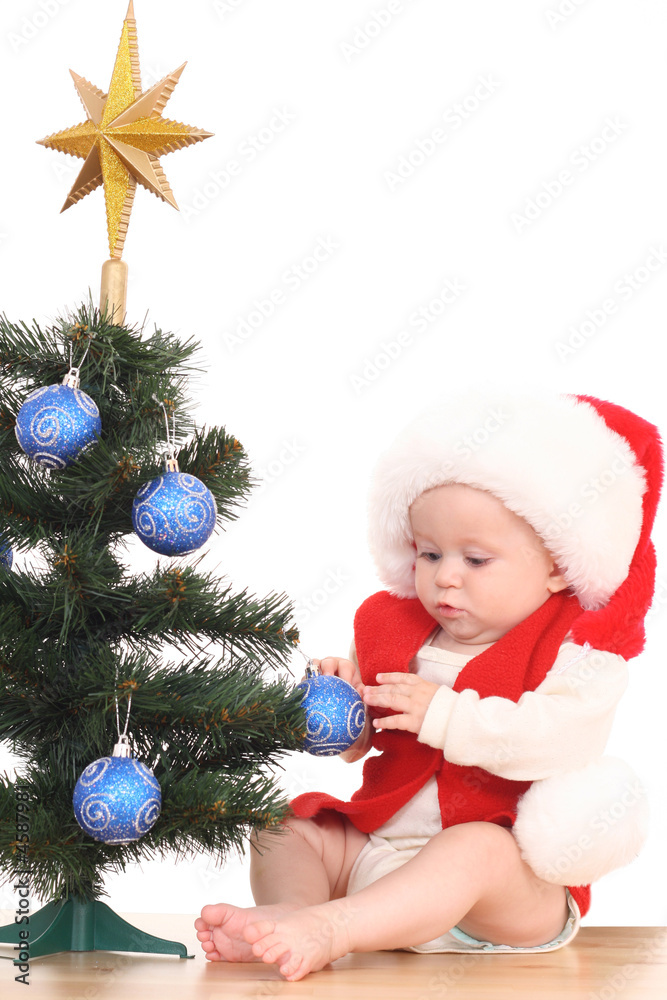 baby girl and Christmas tree