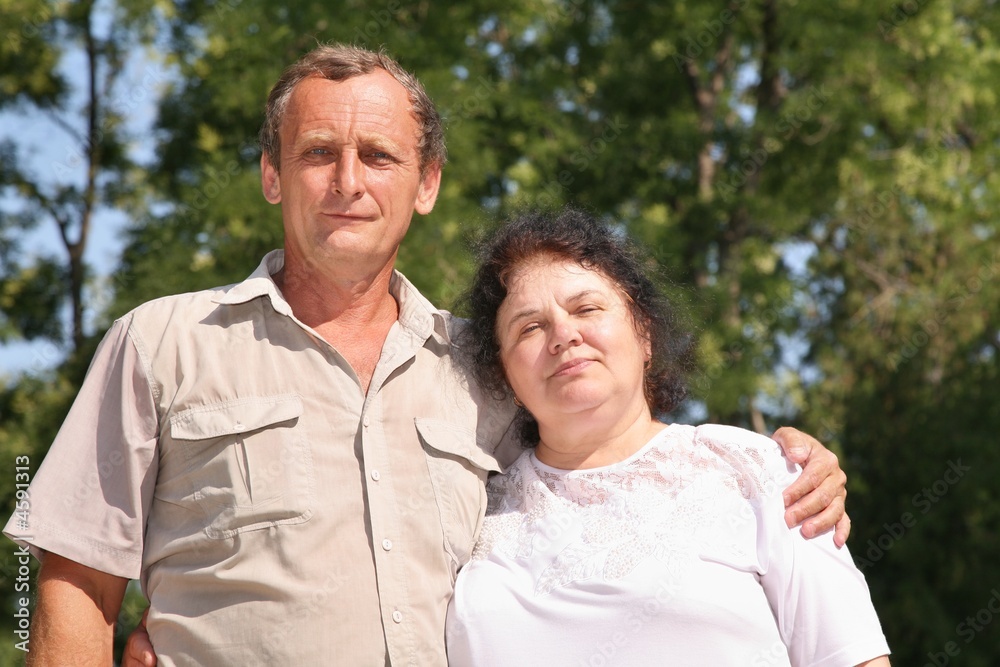 Elderly couple portrait against a nature background Elderly couple portrait against a nature background