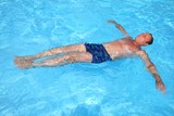 Man floating in the swimming pool 