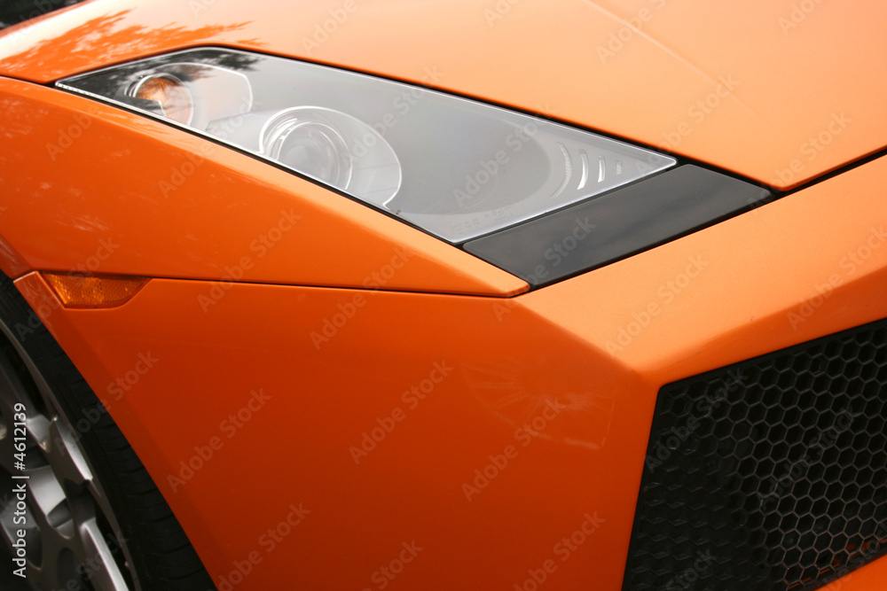 Headlamp on bright orange super car