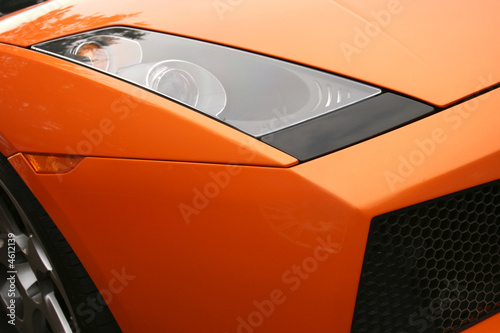 Headlamp on bright orange super car