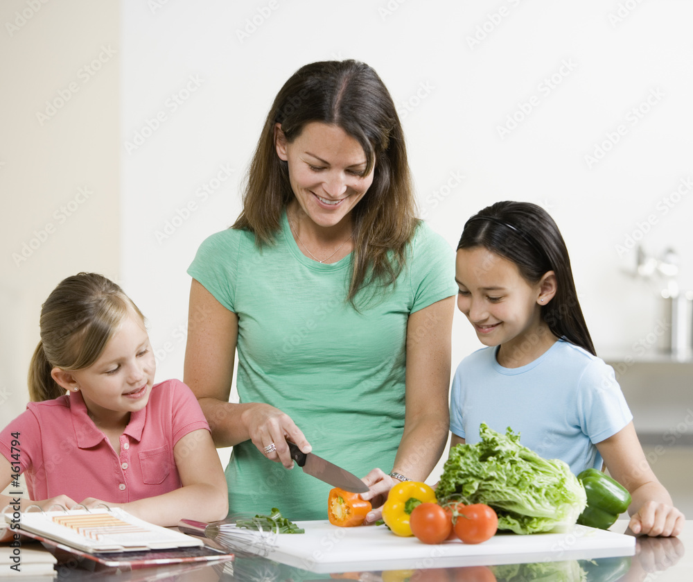 Mother preparing food with Daughters