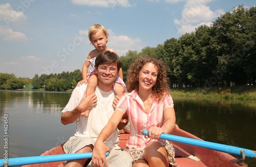 The family  on a boat on the river © Pavel Losevsky
