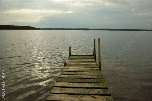 The wooden path to the sea with cloudy sky © catcha