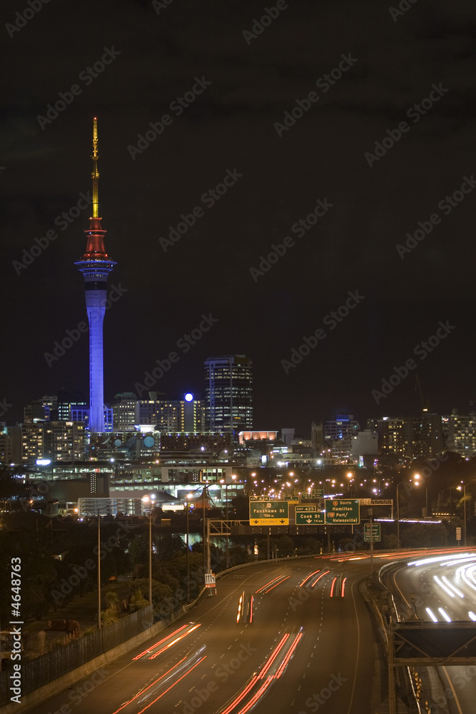 Auckland Sky Tower at Night with Vehicle Lights on the motorway