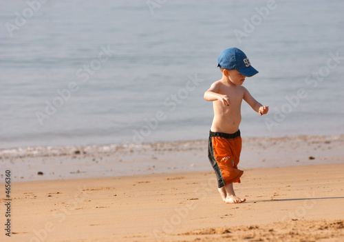 Small boy playing at sandy beach