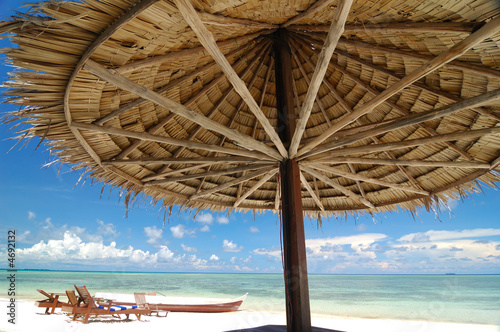 Fototapeta Naklejka Na Ścianę i Meble -  Tropical beach resort with bamboo hut in the foreground
