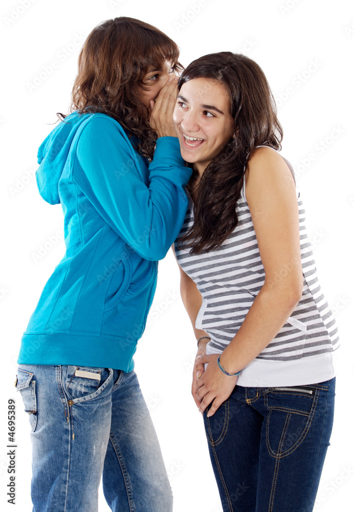 Teenager girls whispering a secret Teenager girls whispering a secret