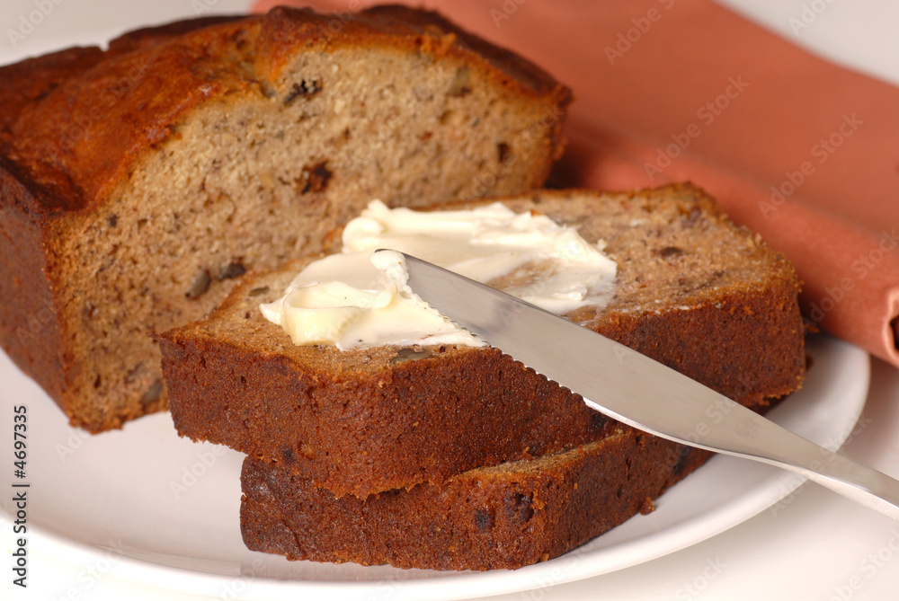 Banana walnut bread with butter on a plate Banana walnut bread with butter on a plate