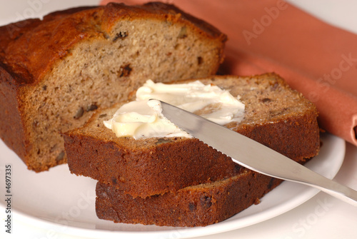 Banana walnut bread with butter on a plate