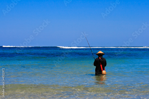 Asian fisherman in sea