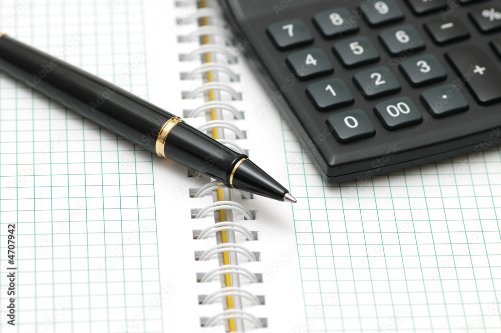 Pen and calculator with shallow depth of field
