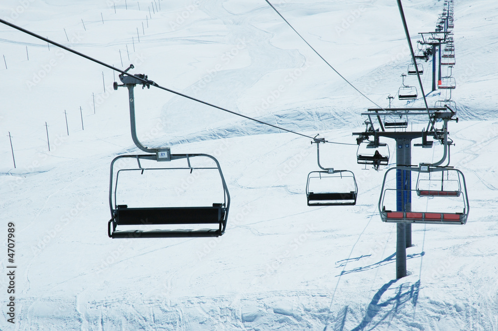 Ski lift chairs on bright winter day Ski lift chairs on bright winter day