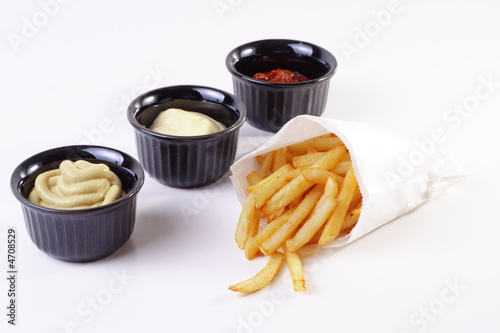 French fries with mustard, mayonnaise and ketchup