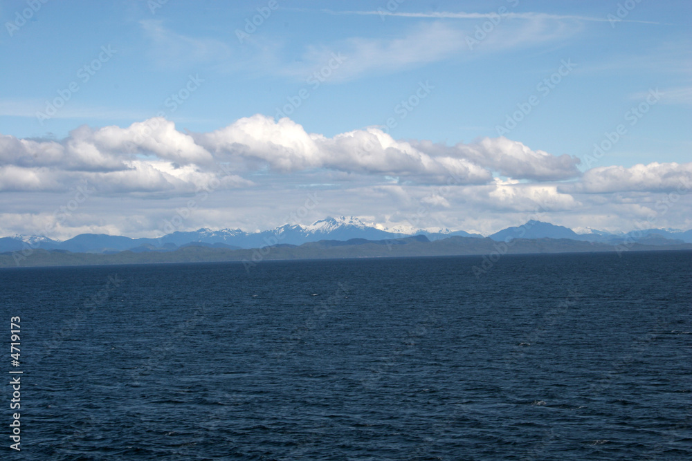 Background of sea, mountains, and clouds