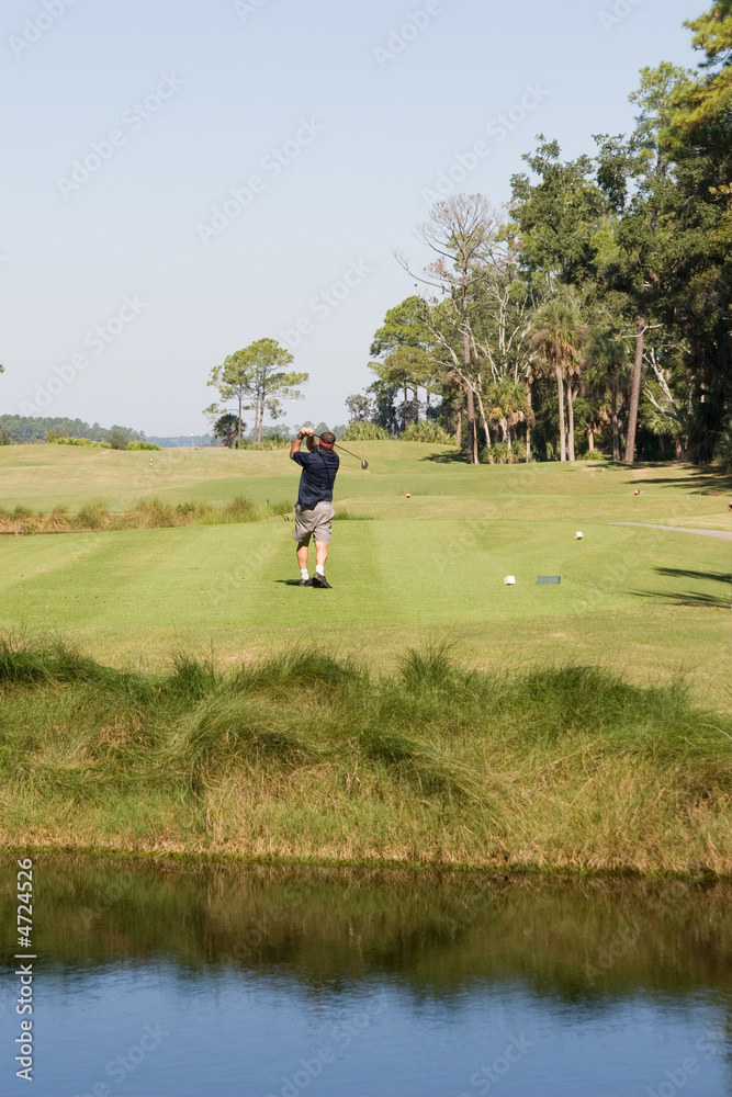 man swinging golf club on green man swinging golf club on green