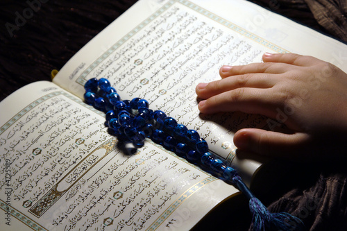 Worshiping hands & reading holy Koran book