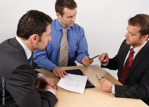Three businessmen handling negotiations.