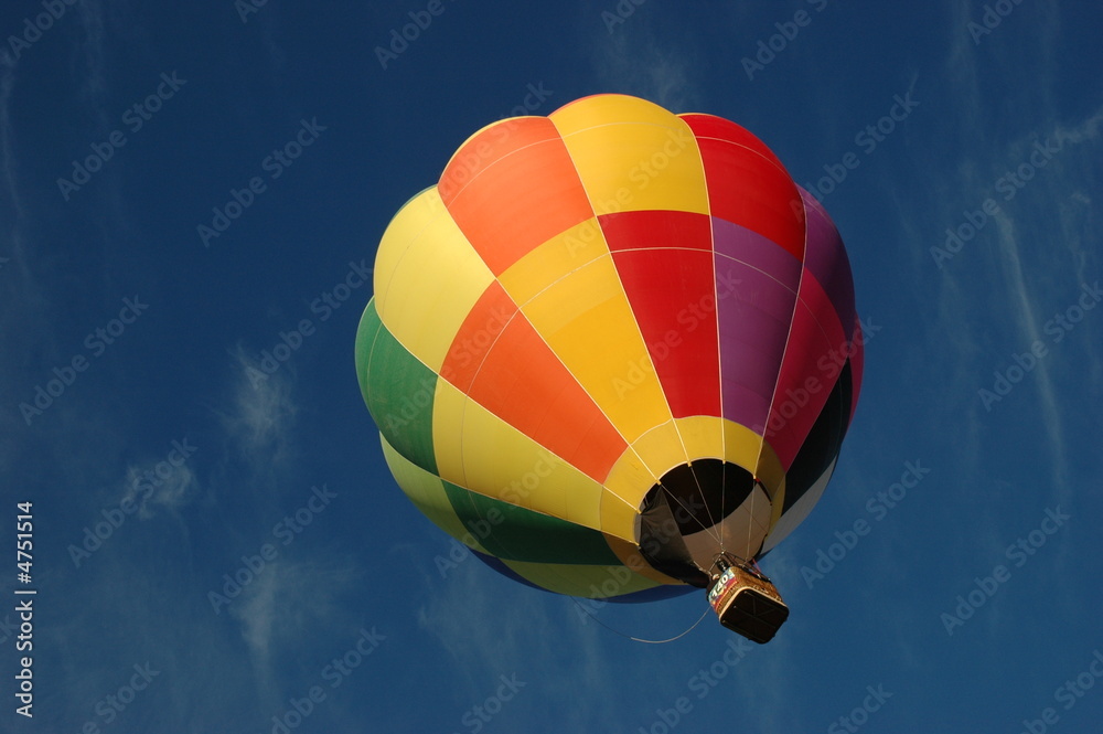 Naklejka premium Bright and colorful hot hair balloon against blue sky