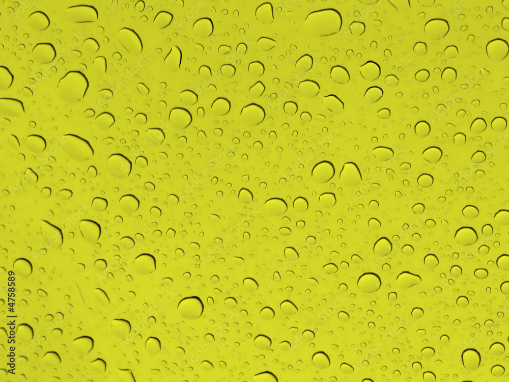 abstract background with drops of water in a yellow glass