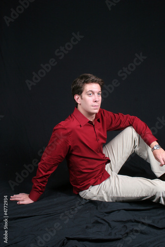 Young man sitting down