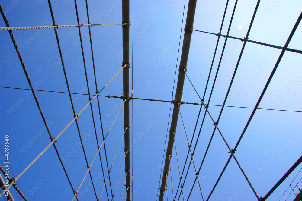 Bridge Cables Crossing In Front of Blue Sky Bridge Cables Crossing In Front of Blue Sky