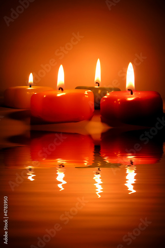 christmas candles and reflection in water