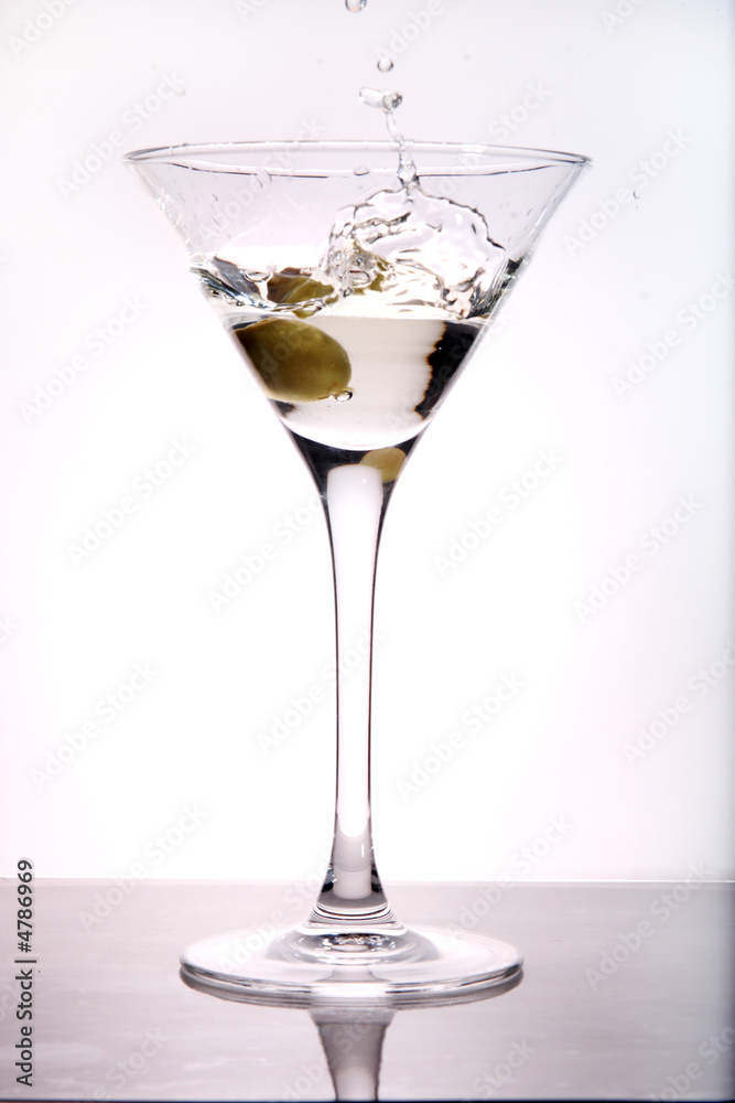 Olive splashing into Martini