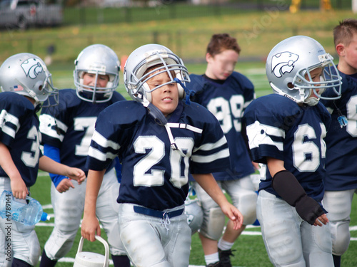 Fotografie young football players walking on sideline