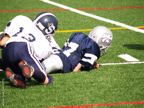 young football player being tackled