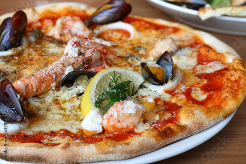 seafood pizza - lobster or langouste, mussels, prawns, squid rin photo