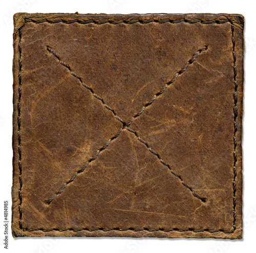 Brown scratched leather patch with stiched edges photo