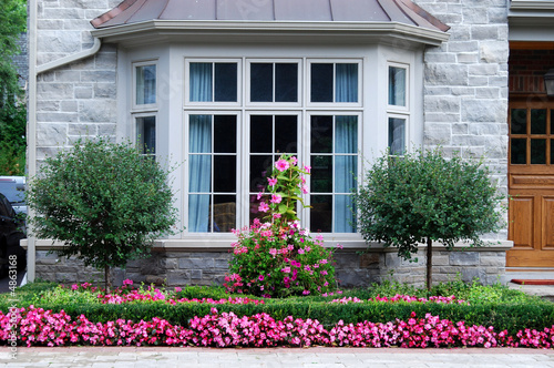 Bay window with row of pink flowers photo